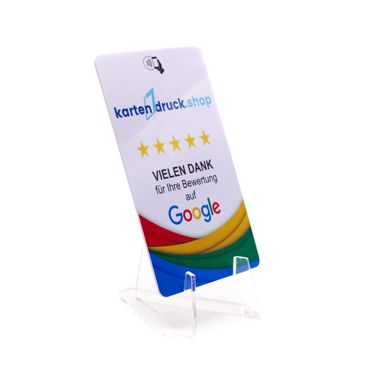 Eine kleine, glasklare Staffelei aus Acryl auf weißem Hintergrund, auf der eine bedruckte Plastikkarte im Hochformat leicht nach hinten geneigt präsentiert wird. Die weiße Karte zeigt oben ein Smartphone-Symbol, das Logo „kartendruck.shop“, fünf gelbe St…